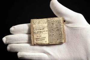 A curator at the Musee des Lettres et Manuscrits displays the miniature manuscript dated 1830 written by Charlotte Bronte, in Paris